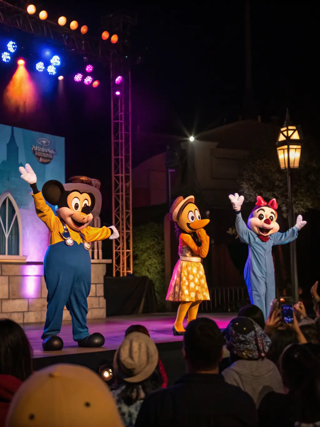 A dynamic image of a theatrical performance in a public square, featuring actors in costume and a diverse audience, emphasizing community engagement.